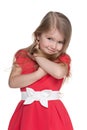 Shy little girl in the red dress Royalty Free Stock Photo