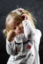 Shy little girl smiling on a black background Royalty Free Stock Photo