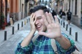 Shy man covering his face while smiling Royalty Free Stock Photo