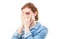 Shy redhead girl covering her face with her hands and peeping into the camera with her fingers. Young woman on white isolated Royalty Free Stock Photo