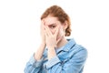 Shy redhead girl covering her face with her hands and peeping into the camera with her fingers. Young woman on white isolated Royalty Free Stock Photo