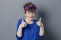 Shy retro 30s woman smiling with two thumbs up Royalty Free Stock Photo