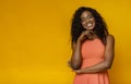 Shy smiling african woman touching her neck Royalty Free Stock Photo