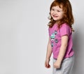 Shy smiling cutie smiling little toddler girl in sportswear studio shot Royalty Free Stock Photo