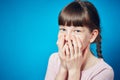 shy smiling embarrassed girl covering mouth with hands. young cute child emotional portrait Royalty Free Stock Photo