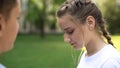 Shy teenager girl looking down, romantic date of students, awkward moment Royalty Free Stock Photo