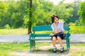 Shy Thai schoolgirl sitting on a bench Royalty Free Stock Photo