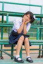 Shy Thai schoolgirl sitting on a stand Royalty Free Stock Photo