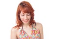 Shy woman looks down and smiles. Redhead girl wears colorful and Royalty Free Stock Photo