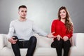 Shy woman and man sitting on sofa. First date. Royalty Free Stock Photo