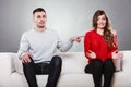 Shy woman and man sitting on sofa. First date. Royalty Free Stock Photo