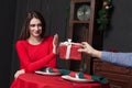 Shy woman refuses gift in restaurant Royalty Free Stock Photo