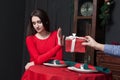 Shy woman refuses gift in restaurant Royalty Free Stock Photo