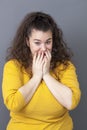 Shy young big woman touching her face for wellness Royalty Free Stock Photo