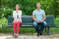 Shy Man And Woman Sitting On Bench