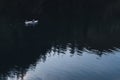 SHYMKENT, KAZAKHSTAN - AUGUST 5, 2023: man on rowing boat with paddles rowing with oars and floating on water on the Royalty Free Stock Photo