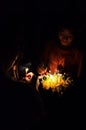 theravada buddhist pilgrim boy with a flower and candle float raft during a religious holy celebration