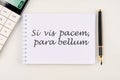 Si vis pacem, para bellum. Latin phrase meaning If you want peace, prepare for the war. on a white notebook