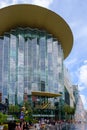 Siam Paragon is a shopping center in the center of Bangkok where people shop, Large white Christmas tree stands in front of the