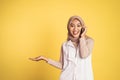 sian woman making a call using a cell phone and presenting copy space Royalty Free Stock Photo