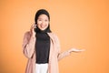 sian woman making a call using a cell phone and presenting copy space Royalty Free Stock Photo