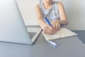 Sian woman sitting at table doing assignments in college library