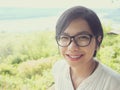 Sian woman smiling on the top of the mountain.