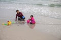 Sianoukville, Cambodia - 4 April 2018: woman and child play in sand of beach. Marine landscape with mother and child Royalty Free Stock Photo
