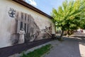 Sianow, pomorskie / Poland - August, 14, 2020: Mural showing old scenes from city life. A painting on the wall of an old tenement