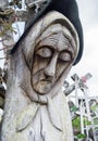 SIAULIAI, LITHUANIA - JULY 28, 2019: Old wooden sculptures on religious themes at the Hill of Crosses