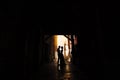 Sibenik, Croatia - 05.06.17: Groom holds bride's hands, standing in the shadow of the courtyard of the old house in