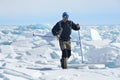 Siberia, Irkutsk region, cape Sagan-Zaba, Russia, March, 10, 2017.Tourist overcomes the hummocks at the Cape of Sagan Zaba on lake