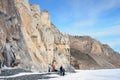 Siberia, Irkutsk region, cape Sagan-Zaba, Russia, March, 10, 2017. Tourists walking on the coast of lake Baikal. Mountain landscap