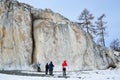 Siberia, Irkutsk region, cape Sagan-Zaba, Russia, March, 10, 2017.Tourists walking near the rocks of Cape Sagan-Zaba in cloudy wea