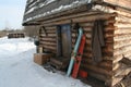 Siberian hunting hut in winter with skis at the entrance