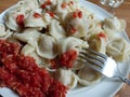 Siberian pelmeni and horseradish sauce, garlic and tomato.