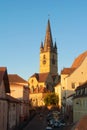 SIBIU, ROMANIA - AUGUST 1, 2017: Evening sunset view to Sibiu old town city center with plenty of parked cars, old vintage retro