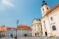 Holy Trinity Roman Catholic Church and city hall at Piata Mare Large Square in Sibiu, Romania Royalty Free Stock Photo