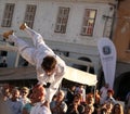 Acrobat balancing on man's head