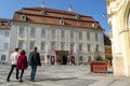 Young students heading towards Brukenthal National Museum in Sibiu main pedestrian square, on a sunny Summer day Royalty Free Stock Photo