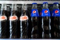Sibiu, Romania - May, 11 2022: Close up of Pepsi Cola glass bottles in supermarket fridge. Vintage and modern Pepsi