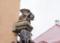 The top of the pillar next to the smithy, decorated with gargoyles and studded with various forging items in Sibiu city in Romania