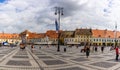 Sibiu, Romania - 2019. Tourist wondering in the panoramic The Big Square Piata Mare of Sibiu looking and the City hall Royalty Free Stock Photo