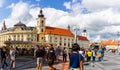 Sibiu, Romania - 2019. Tourist wondering in the panoramic The Big Square Piata Mare of Sibiu looking and the City hall Royalty Free Stock Photo