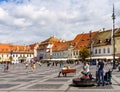 Sibiu, Romania - 2019. Tourist wondering in the panoramic The Big Square Piata Mare of Sibiu looking and the City hall Royalty Free Stock Photo