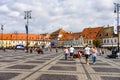 Sibiu, Romania - 2019. Tourist wondering in the panoramic The Big Square Piata Mare of Sibiu looking and the City hall Royalty Free Stock Photo