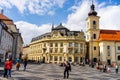 Sibiu, Romania - 2019. Tourist wondering in the panoramic The Big Square Piata Mare of Sibiu looking and the City hall Royalty Free Stock Photo