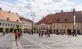 Sibiu, Romania - 2019. Tourist wondering in the panoramic The Big Square Piata Mare of Sibiu looking and the City hall Royalty Free Stock Photo