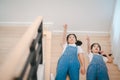 Sibling Asian girls having fun on the stairs