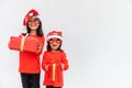 Sibling Asian girls in red Santa hat with gift boxes on white background